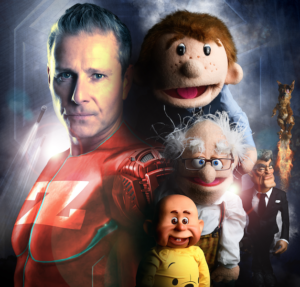 A picture of Paul Zerdin dressed like a superhero surrounded by his puppets