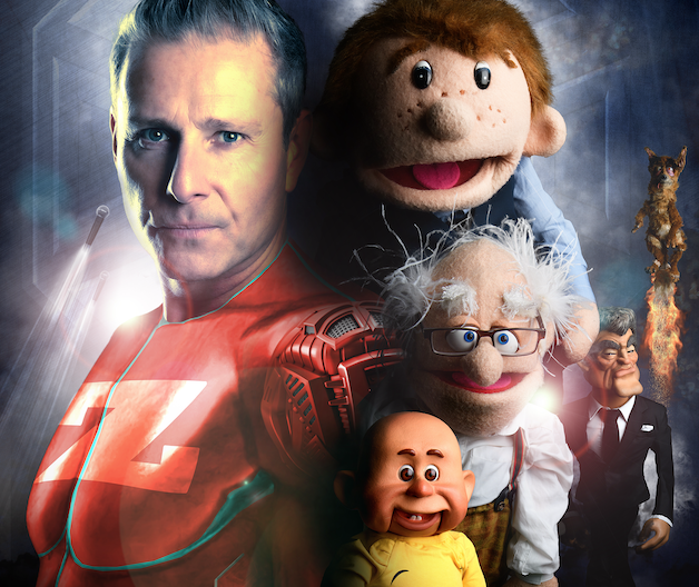 A picture of Paul Zerdin dressed like a superhero surrounded by his puppets